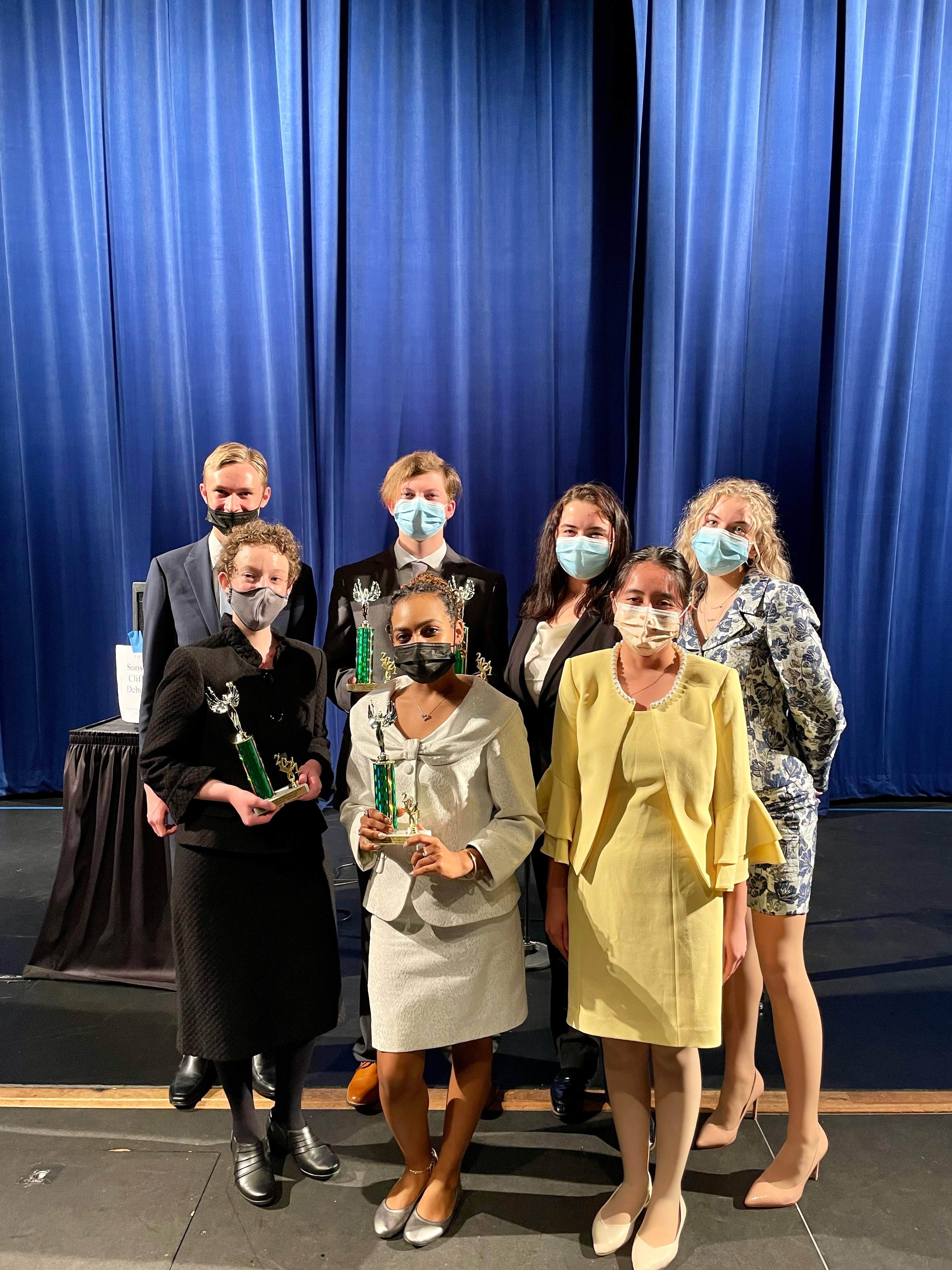 Speech team poses with awards from tournament